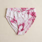 Pink and white tie-dye underwear on a beige background