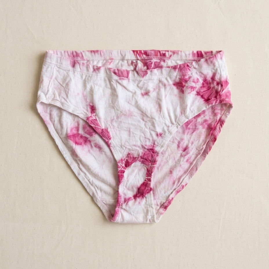 Pink and white tie-dye underwear on a beige background