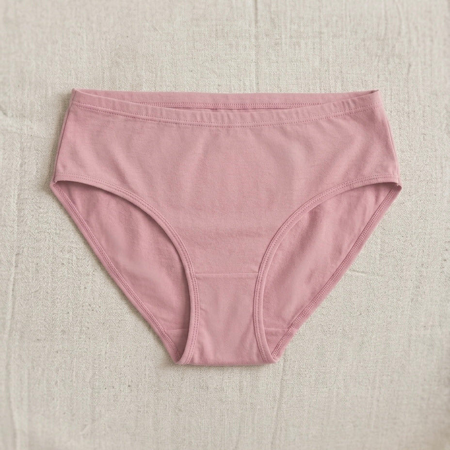 Pink underwear on a beige textured background
