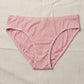 Pink underwear on a beige fabric background