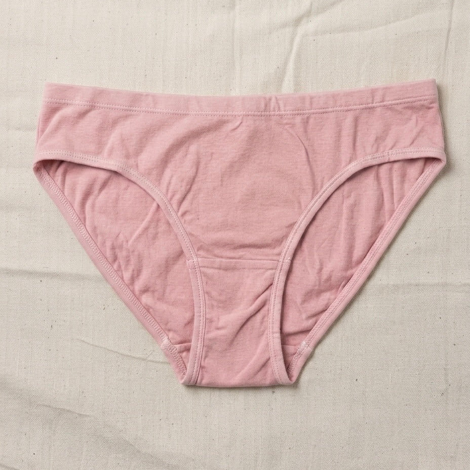 Pink underwear on a beige fabric background